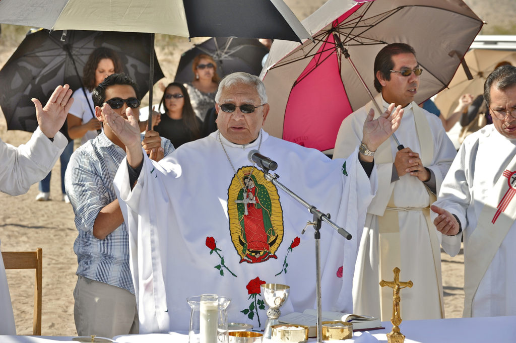 Bishop Ricardo Ramirez of Las Cruces, N.M., celebrates Mass along the U.S.-Mexico border near Anapra, New Mexico, Nov. 2., 2012. The retired bishop will be the guest homilist at the Diocese of Phoenix's annual "Red Mass," which marks the beginning of the Arizona legislative session. (CNS file photo/Brian Kanof)