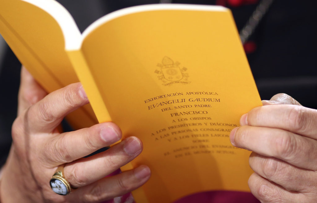 A copy of the apostolic exhortation "Evangelii Gaudium" ("The Joy of the Gospel") by Pope Francis is seen during a news conference at the Vatican Nov. 26. In his first extensive piece of writing as pope, Pope Francis lays out a vision of the Catholic Chu rch dedicated to evangelization, with a focus on society's poorest and most vulnerable, including the aged and unborn. (CNS photo/Alessandro Bianchi, Reuters)