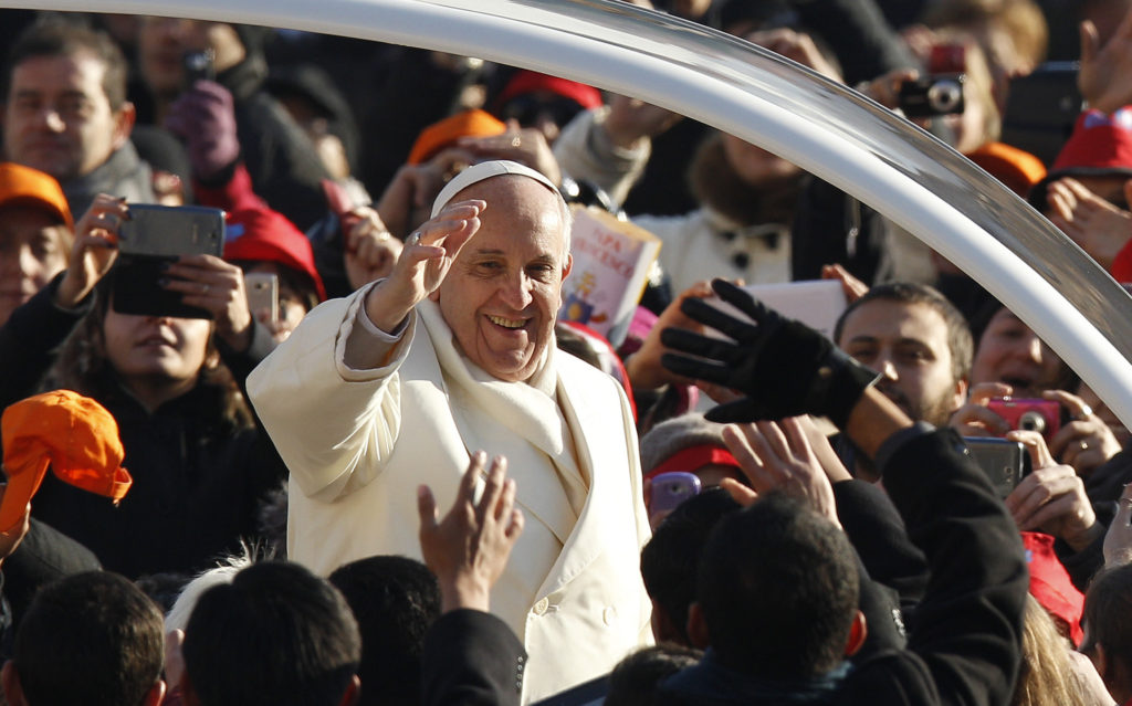 Pope Francis greets the crowd as he arrives to lead his general audience in St. Peter's Square at the Vatican Dec. 11. Pope Francis was named as Time magazine's "Person of the Year." (CNS photo/Paul Haring)