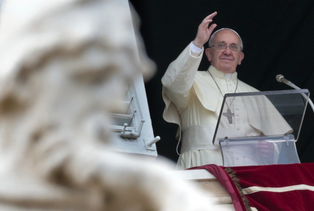 Pope Francis waves as he leads the Angelus from the window of his studio overlooking St. Peter's Square at the Vatican Dec. 26. (CNS photo/Tony Gentile, Reuters)