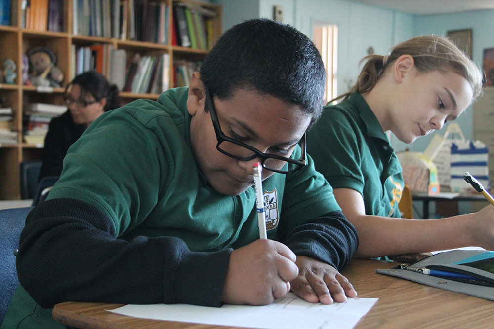 St. Agnes fifth-graders Luis Cervantes and Kennedy Campbell refine poems written as letters to God they will submit to the “Expressions of Faith” contest. (Ambria Hammel/CATHOLIC SUN)