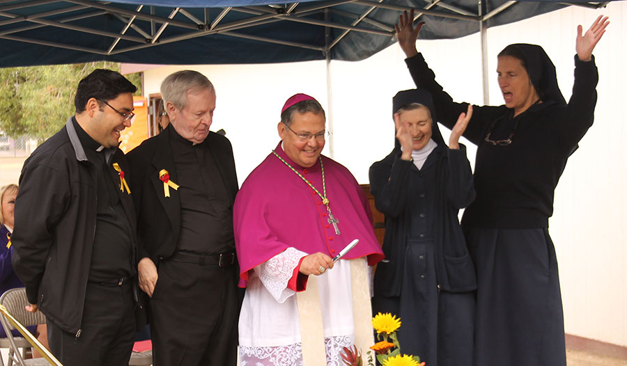 Auxiliary Bishop Eduardo A. Nevares cuts the ribbon at the St. Vincent de Paul School expansion project dedication. (Ambria Hammel/CATHOLIC SUN)