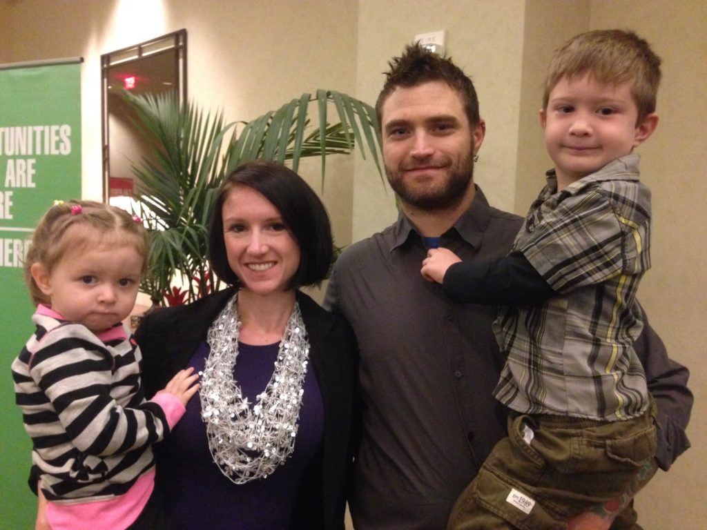 Megan and Shane Kaiser hold their children Berlin and Gavin. The former  St. Vincent de Paul clients now sponsor needy families.