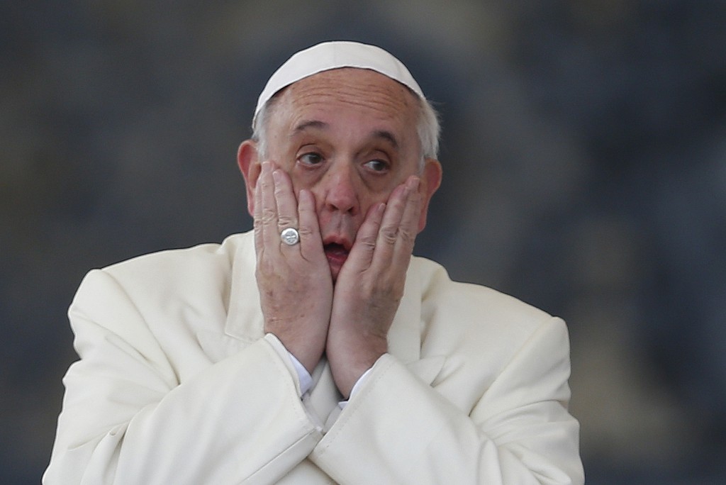 Pope Francis rubs his face after completing the speaking part of his general audience in St. Peter's Square at the Vatican Jan. 15. (CNS photo/Paul Haring)