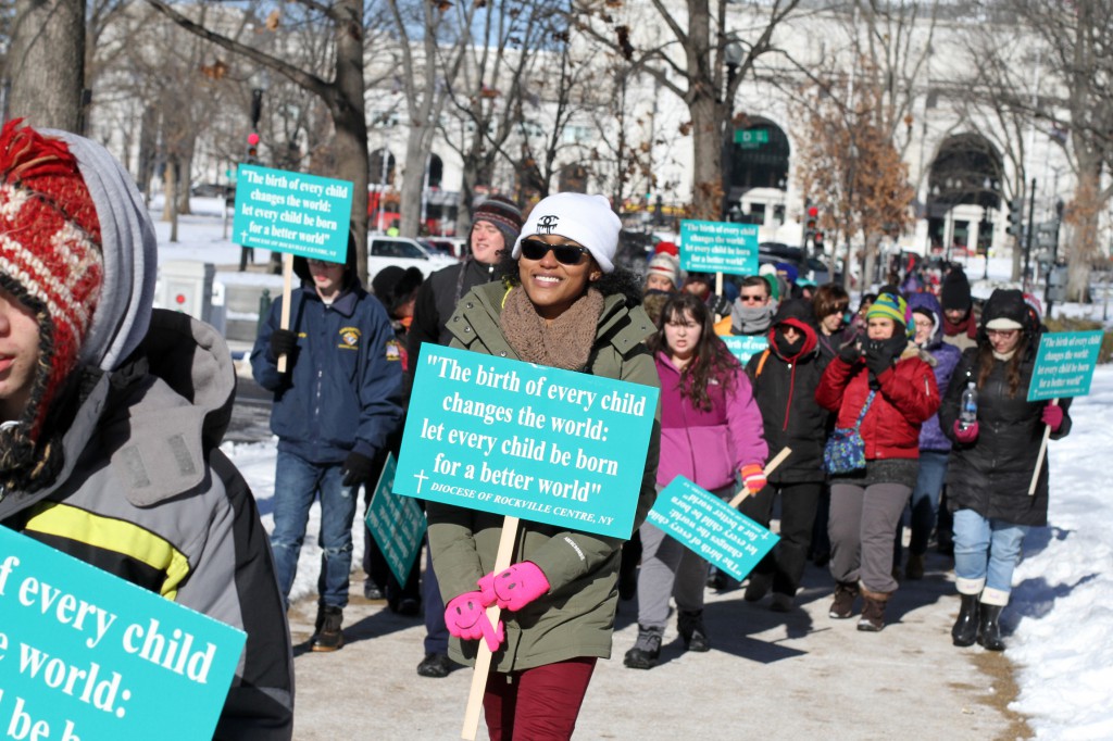 Shanya McCleary of St. Mary Parish in East Islip, N.Y., smiles as she and fellow pro-life advocates walk from Union Station to participate in the March for Life in Washington Jan. 22. Bitter cold and snow did not stop tens of thousands of people from marching against abortion on the 41st anniversary of the Supreme Court's Roe v. Wade decision that legalized abortion across the nation. (CNS photo/Gregory A. Shemitz, Long Island Catholic)