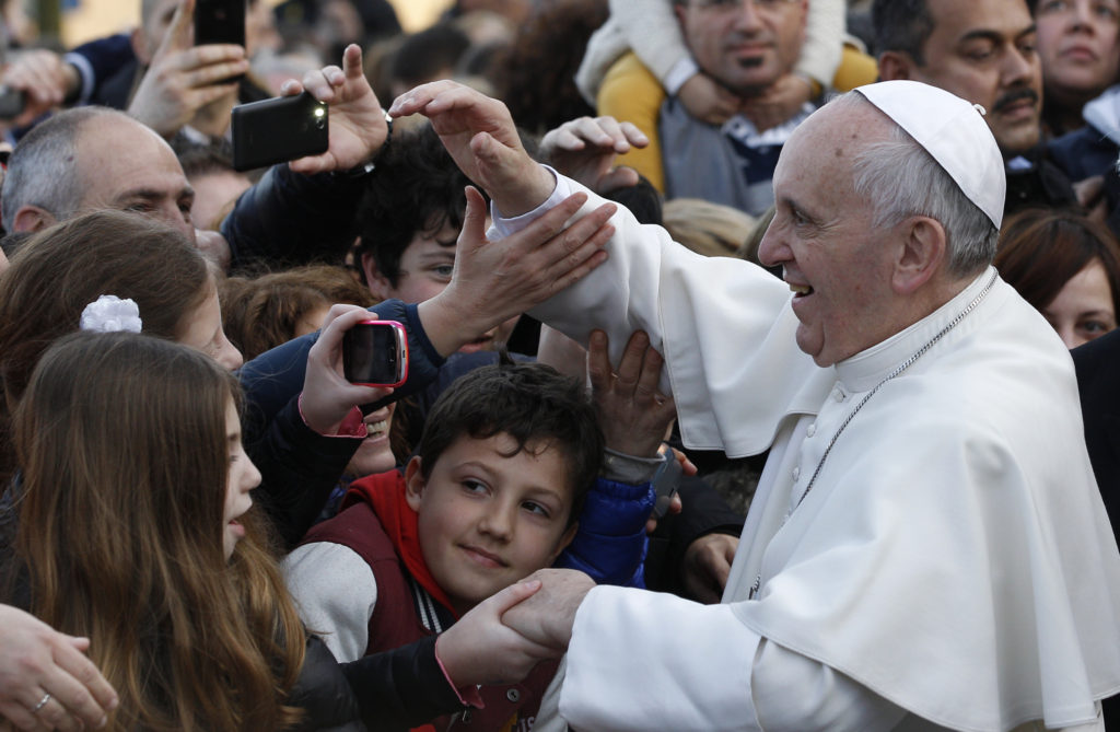 Pope Francis greets the crowd as he visits St. Thomas the Apostle Parish on the outskirts of Rome Feb. 16. (CNS photo/Paul Haring)