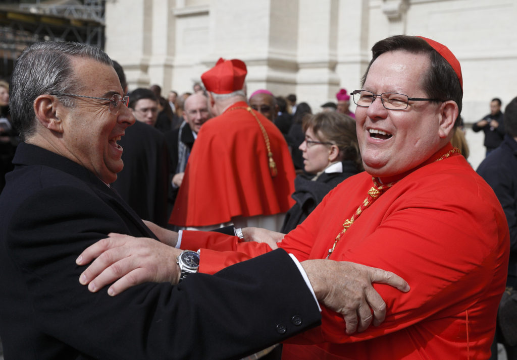 Cardinal Gerald Lacroix of Quebec embraces a well-wisher after attending Pope Francis' Mass with new cardinals in St. Peter's Basilica at the Vatican Feb. 23. The previous day, Pope Francis created 19 new cardinals from 15 countries at a consistory attended by his predecessor, retired Pope Benedict XVI. (CNS photo/Paul Haring)  