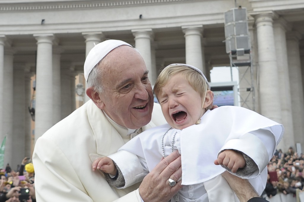 Pope Francis blesses a child dressed as the pontiff as he arrives to lead his general audience in St. Peter's Square at the Vatican Feb. 26.  (CNS photo/L'Osservatore Romano via Reuters) 