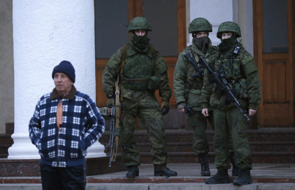 Armed men patrol at the airport in Crimea, Ukraine, Feb. 28. Church leaders in Ukraine appealed for peace in the Crimea peninsula as the government accused Russia of "carrying out an armed invasion." (CNS photo/David Mdzinarishvili, Reuters)  