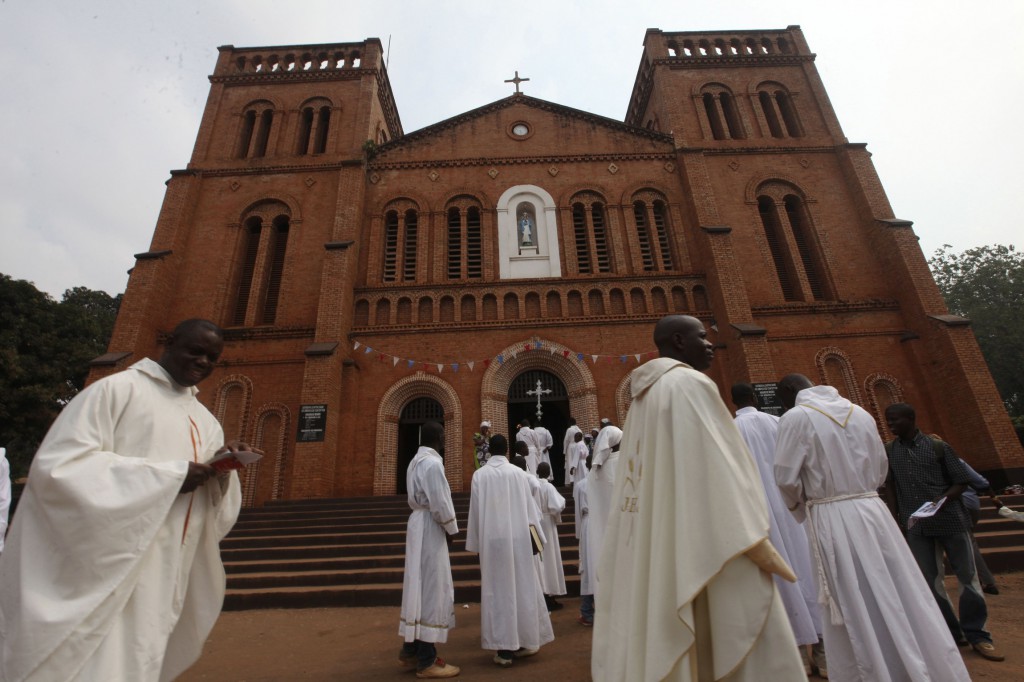 Members of the clergy arrive for Mass in late 2013 at Notre Dame Cathedral of the Immaculate Conception in Bangui, Central African Republic. Catholic leaders in the Central African Republic praised the courage of missionary priests and nuns who remain in the country during the current conflict, despite offers of evacuation. (CNS photo/Luc Gnago, Reuters)