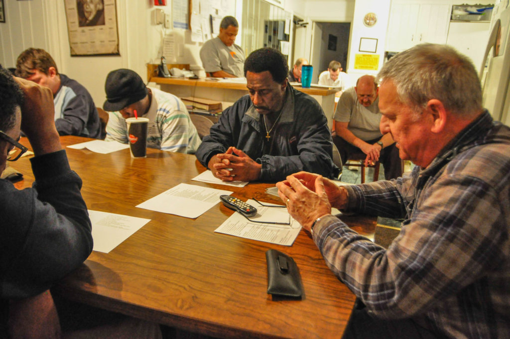 Deacon Ted Welsh, far right, of St. Joseph Parish in Madison, Tenn., leads a weekly prayer service for former prisoners who are making the transition back into society after their release. The prayer service was held at the Aphesis House, a halfway house in Madison, which several men in transition now call home. (CNS photo/Andy Telli, Tennessee Register)