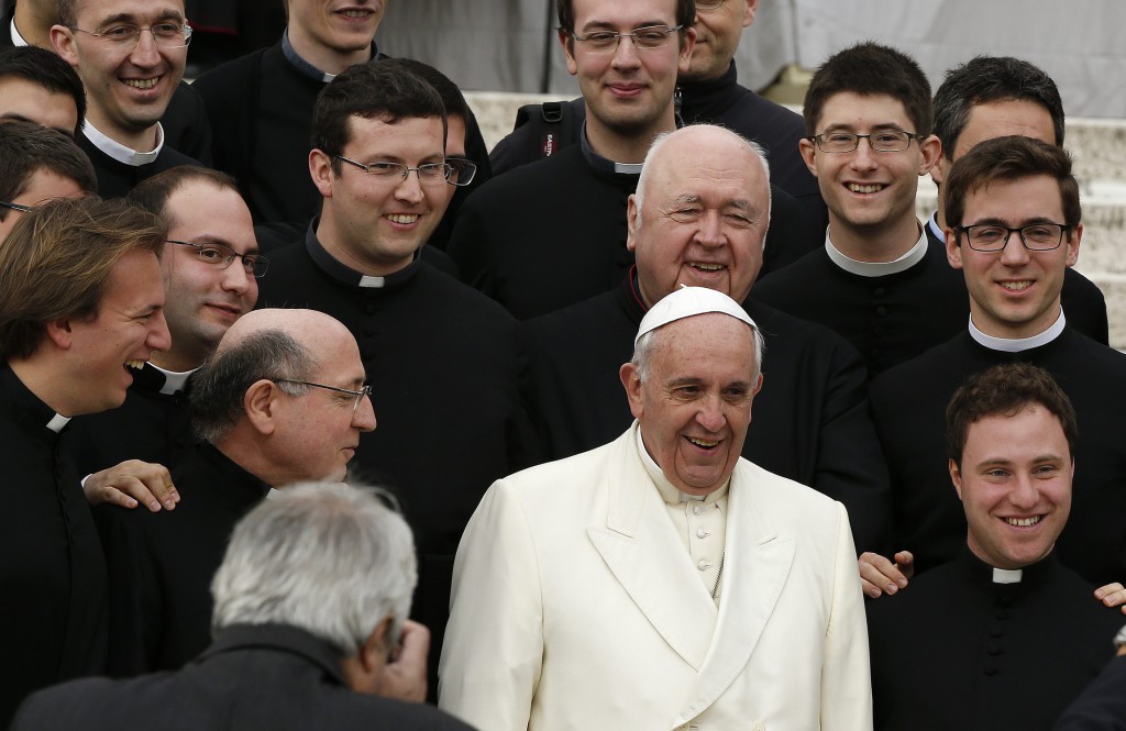 Pope Francis poses with a group of religious men after his general audience in St. Peter's Square at the Vatican Feb. 26. (CNS photo/Tony Gentile, Reuters)