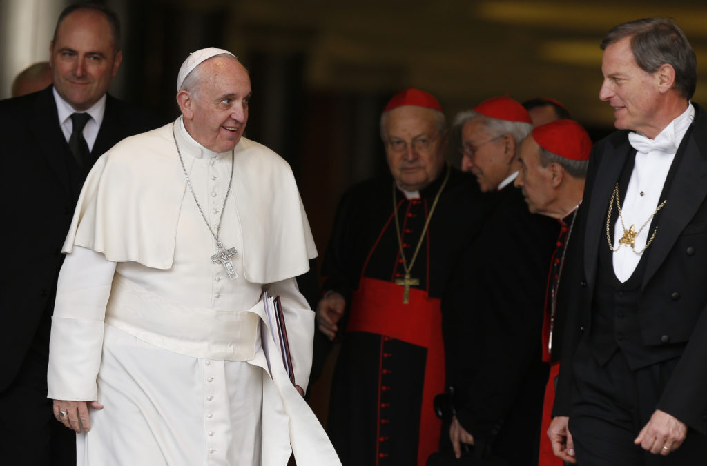 Pope Francis and cardinals leave a meeting of cardinals in the synod hall at the Vatican Feb. 20. The pope asked the world's cardinals and those about to be made cardinals to meet at the Vatican Feb. 20-21 to discuss the church's pastoral approach to the family. (CNS photo/Paul Haring)