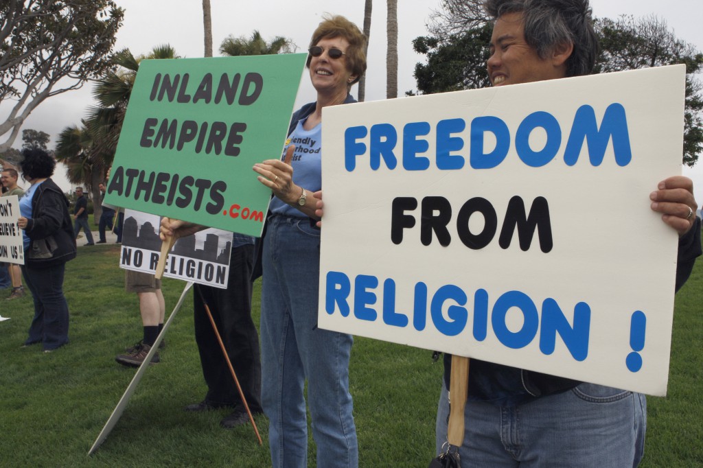 A small group of agnostics, atheists and freethinkers gather for a streetside demonstration in Laguna Beach, Calif., in May last year. A small minority of Americans -- 5 percent -- say they do not believe in God or any universal spirit. About a quarter of those define themselves as atheist. (CNS photo/Nancy Wiechec) 