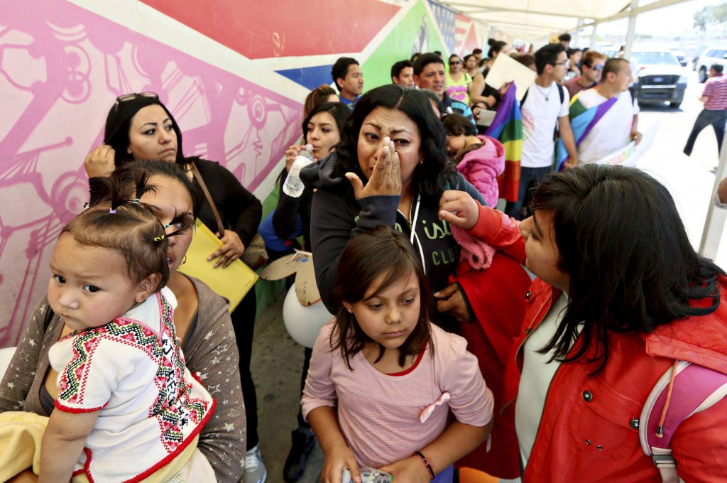 Cecilia Garcia wipes away a tear as she stands in line with deportees during a protest in Tijuana, Mexico, March 16. Federal judges' rulings in two cases may ease detention for some immigrants, and a federal agency clarified Border Patrol policies for use of force at the border. (CNS photo/ Sandy Huffaker, Reuters) 
