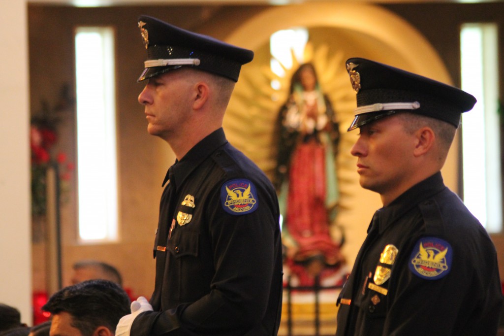 Members of the Phoenix Police Department stand at attention as the names of those in law enforcement and emergency personnel who died over the past year— both in the line of duty and non-work-related causes — are read during the annual Blue Mass at Ss. Simon and Jude Cathedral in this 2013 file photo. (Ambria Hammel/CATHOLIC SUN)