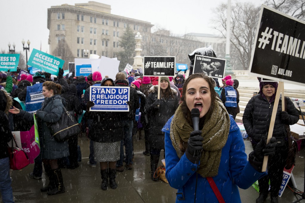 A woman leads a chant in front of the U.S. Supreme Court in Washington against the federal government's contraceptive mandate March 25. The Supreme Court heard oral arguments in lawsuits filed against the mandate by Hobby Lobby Stores and Conestoga Wood Specialties on religious rights grounds. (CNS photo/Tyler Orsburn)