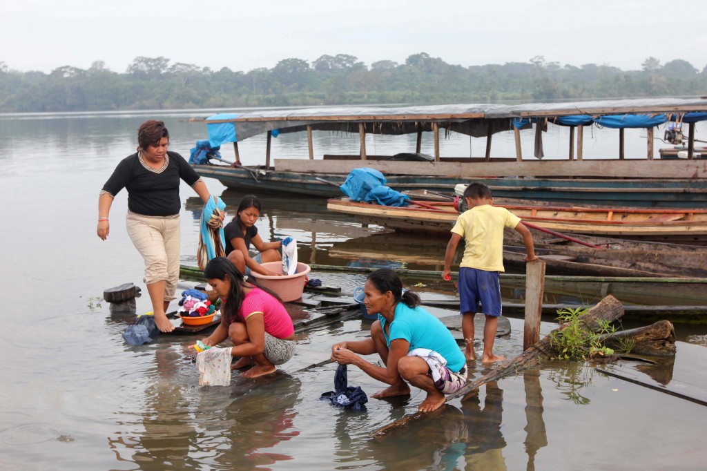 Residents of Dos de Mayo, Peru, wash their clothes in a nearby lake. Water, soil and sediments in the Amazon tributary contain heavy metals and other residue from more than four decades of oil production. In all 17 communities tested, the rivers, lakes o r wells that provide drinking water were deemed unsafe. (CNS photo/Barbara Fraser)