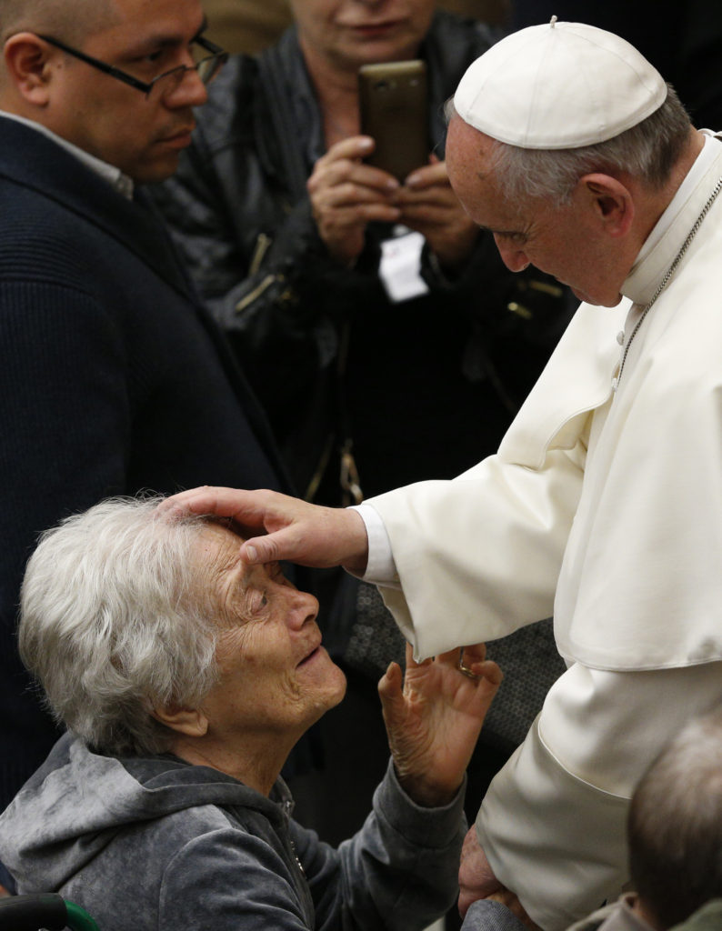 Pope Francis blesses a woman during an audience with people who are deaf or blind in Paul VI hall at the Vatican March 29. (CNS photo/Paul Haring)