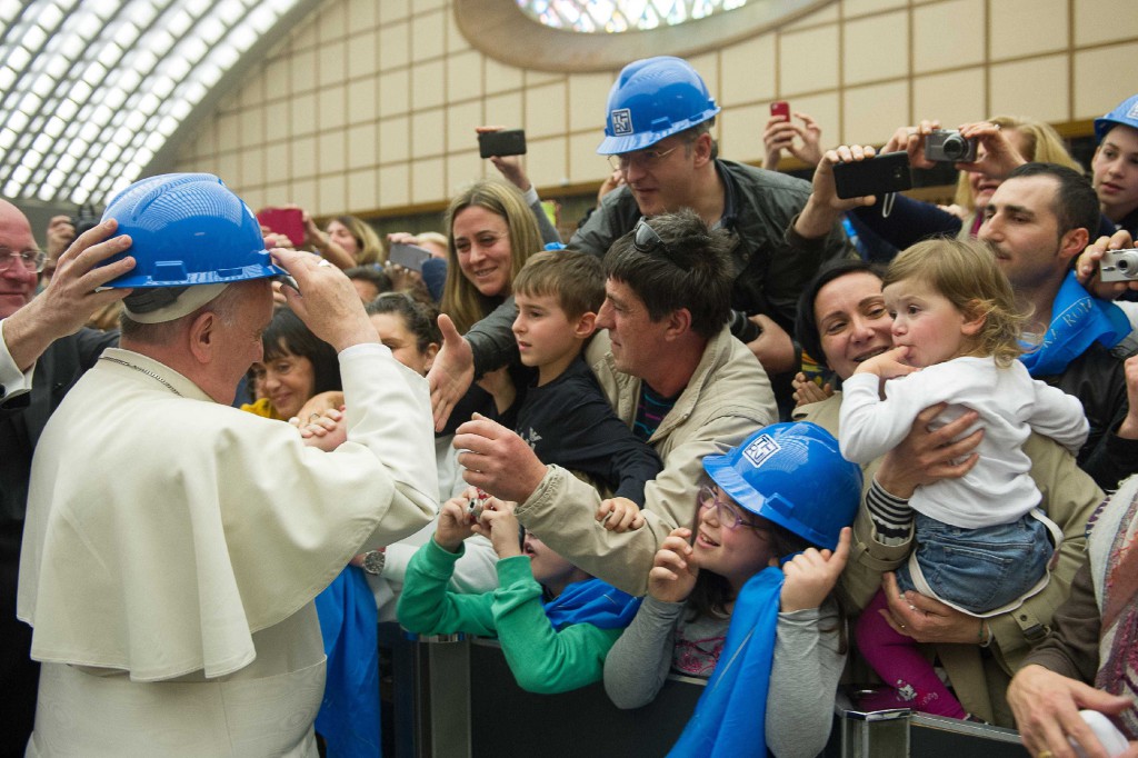 Pope Francis wears a hard hat during a special audience with pilgrims from the Diocese of Terni, Italy, in Paul VI hall at the Vatican March 20. (CNS photo/L'Osservatore Romano via Reuters)