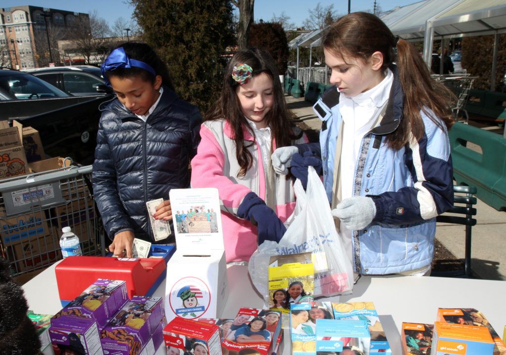 Catholic Girl Scouts with Troop 508 sell Girl Scout cookies in late February at a shopping plaza in Great Neck, N.Y. Some claim the Girl Scouts promotes Planned Parenthood and its advocacy of birth control and abortion, but the organization strongly denies such accusations. A U.S. bishops' committee plans to develop a resource bishops can share with priests, youth ministers, pro-life directors, educators others in their diocese on Catholic identity for Catholic Scout troops and guidance for parents. (CNS photo/Gregory A. Shemitz)