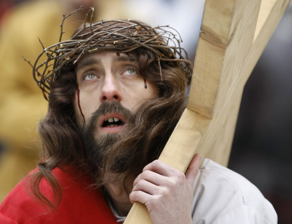 An actor carries a cross during a re-enactment of Christ's crucifixion on Good Friday as part of Holy Week celebrations in Wejherowo, Poland,  March 29. (CNS photo/Kacper Pempel, Reuters)
