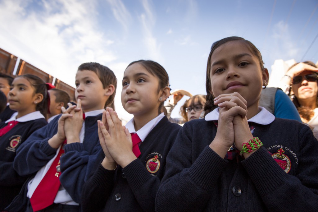 Catholic school students attend a Mass with U.S. bishops at the U.S.-Mexico border fence in Nogales, Ariz., April 1. (CNS photo/Nancy Wiechec)