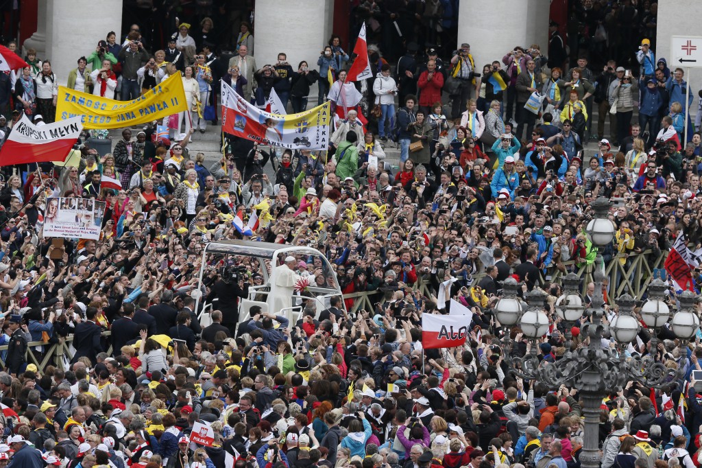 Pope Francis waves to the crowd as he arrives for the canonizations of Sts. John XXIII and John Paul II at the Vatican April 27. (CNS photo/Paul Haring)