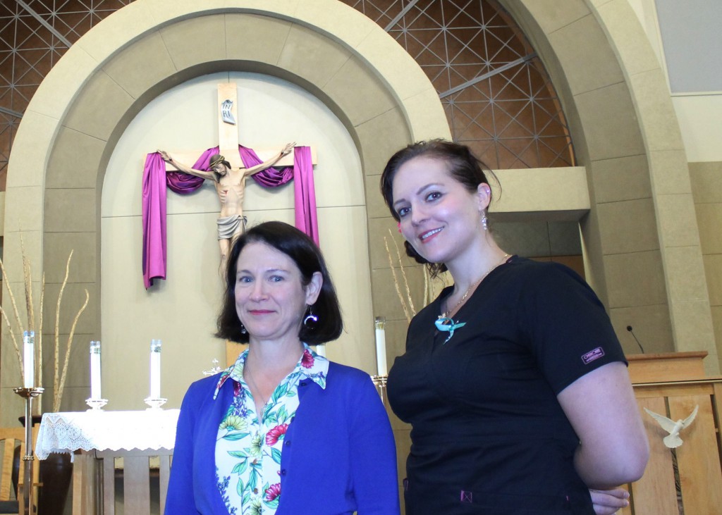 Kasandra Bujold, who will be baptized, confirmed and receive her first Communion at St. Mary Magdalene Parish April 19, stands inside the church with her sponsor, Laura Cristiano. (Joyce Coronel/CATHOLIC SUN)