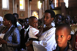A woman holds a child during Mass at St. Famille Church in Kigali April 6, one day ahead of the commemoration of the 20th anniversary of the Rwandan genocide. An estimated 1 million people were murdered in savage acts of ethnic violence. (CNS photo/Noor Khamis, Reuters)