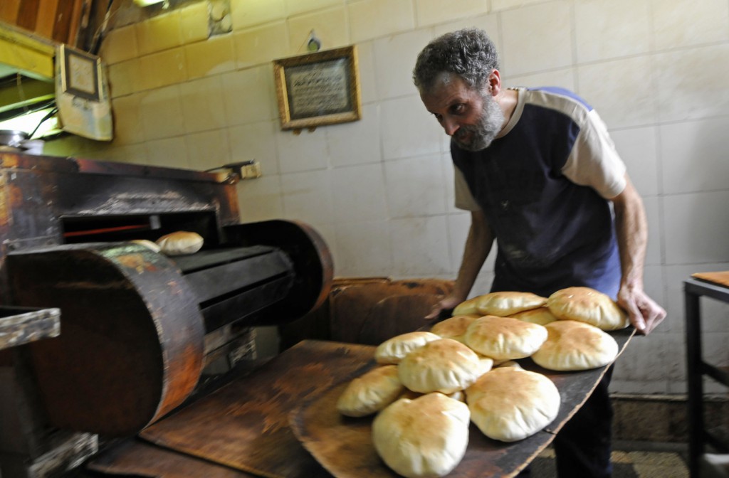 Afif Abu Omar bakes pita bread at his bakery March 10 in the Israeli town of Nazareth, the starting point on the 40-mile Jesus Trail. The new hiking tour begins in Nazareth and passes through other places of Christ's ministry. (CNS photo/Debbie Hill) 