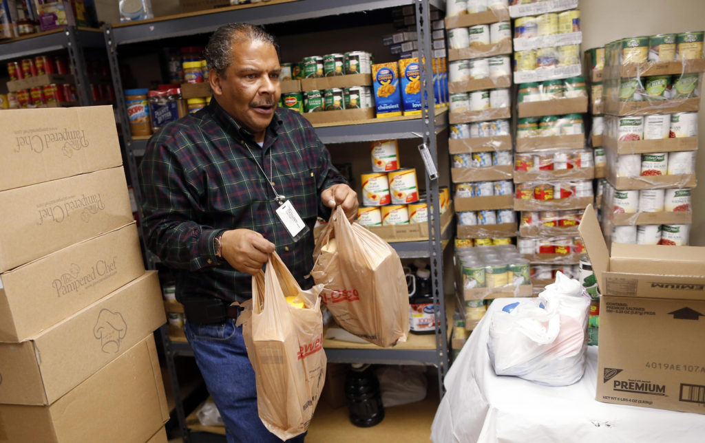 Food pantry handler Kenneth Willis carries bags of food Nov. 1 for the Emergency Assistance Department at Chicago Catholic Charities. Archbishop Francis A. Chullikatt, Vatican nuncio to the United Nations, told world leaders Oct. 29 they must share one goal of food security so fewer and fewer people around the world will suffer from poverty and hunger. (CNS photo/Jim Young, Reuters)