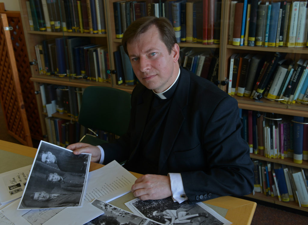 Fr. Pawel Rytel-Andrianik, a native of Poland, does research in the Yad Vashem Holocaust Museum's Library in Jerusalem March 19. Fr. Rytel-Andrianik, professor of Scripture at the Pontifical University of the Holy Cross in Rome, is collecting the stories and building lists of names of average Poles, including priests and nuns, who risked their lives to save Jews during the Holocaust. (CNS photo/Debbie Hill) 