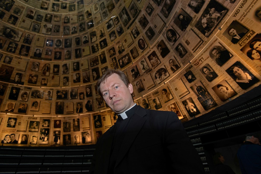 Fr. Pawel Rytel-Andrianik, a native of Poland, stands in the Hall of Names at the Yad Vashem Holocaust Museum in Jerusalem March 19. Father Rytel-Andrianik, professor of Scripture at the Pontifical University of the Holy Cross in Rome, is collecting the stories and building lists of names of average Poles, including priests and nuns, who risked their lives to save Jews during the Holocaust. (CNS photo/Debbie Hill)