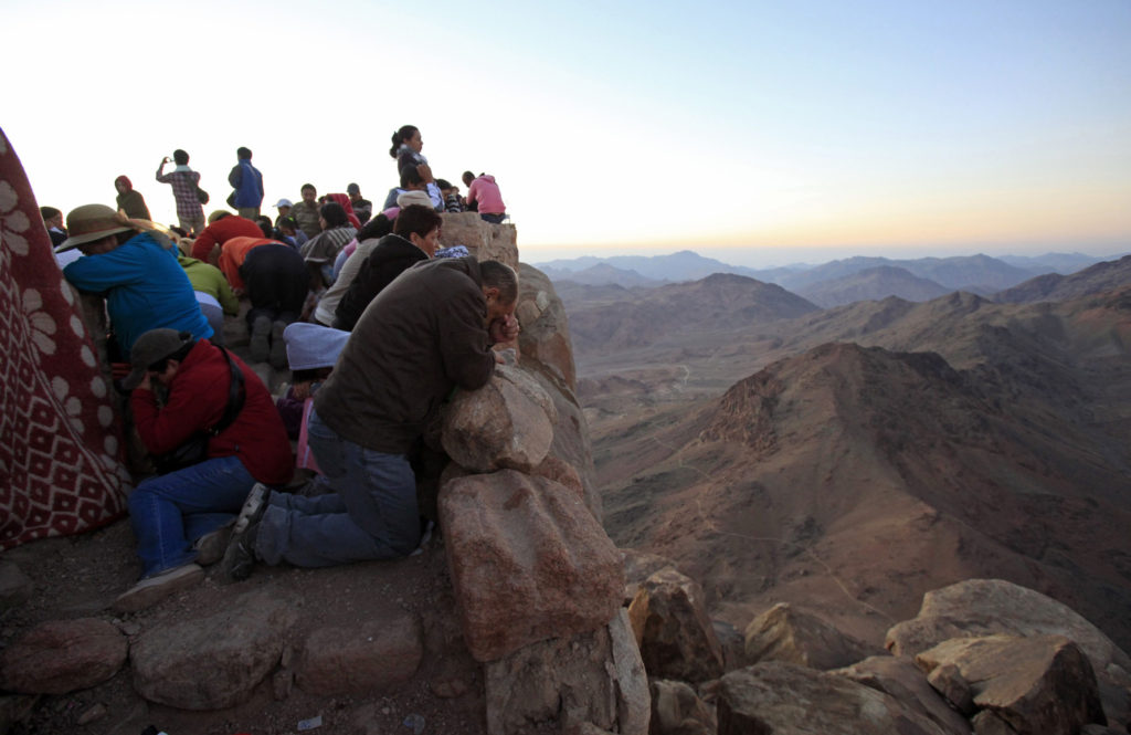 Worshipers pray outside a church on the summit of Mount Sinai during sunrise in the Sinai Peninsula in this 2010 file photo. According to the Bible this is where Moses received the Ten Commandments from God. (CNS photo/Goran Tomasevic, Reuters) 