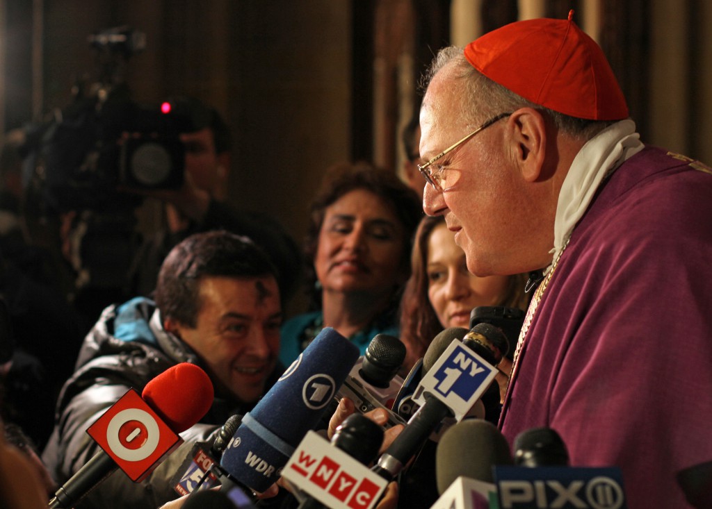 Thanking communications professionals who work for the Catholic Church, Cardinal Timothy M. Dolan of New York also shared with them tips he said he learned at the "school of hard knocks." Cardinal Dolan is seen in 2013 speaking with reporters after celebrating an Ash Wednesday Mass at St. Patrick's Cathedral. (CNS photo/Gregory A. Shemitz)