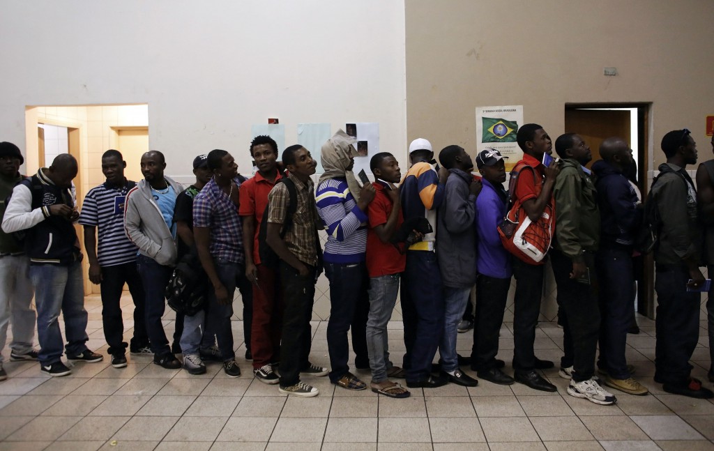Haitian immigrants line up April 29 to sign their documents in Our Lady of Peace Catholic Church in Sao Paulo. Two years ago the Brazilian government announced the creation of a humanitarian visa exclusively for Haitian refugees after the 2010 earthquake on the island. (CNS photo/Nacho Doce)  
