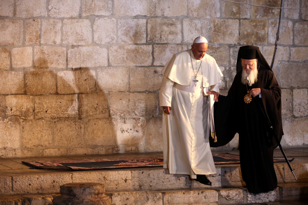 Pope Francis walks with Ecumenical Patriarch Bartholomew of Constantinople at Jerusalem's Church of the Holy Sepulcher May 25, the 50th anniversary of the meeting between Pope Paul VI and Patriarch Athenagoras. (CNS photo/ Abir Sultan, EPA)