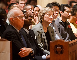Harvard University President Drew Faust, center, listens to remarks by Boston Auxiliary Bishop Arthur L. Kennedy during a May 12 holy hour at St. Paul Church in Cambridge, Mass. The service was held in reaction to plans for a satanic ritual "black mass" to take place in a pub on the Harvard campus. The student group organizing the satanic event ultimately cancelled it. (CNS photo/Gregory L. Tracy, Pilot)