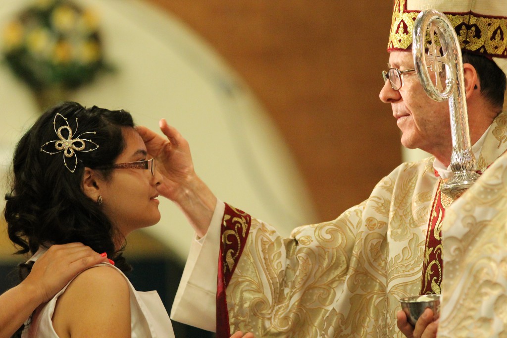Magalia Rincon, a student in the faith formation program at Ss. Simon and Jude Cathedral, was confirmed by Bishop Thomas J. Olmsted at the Easter Vigil Mass April 19. (Tamara Tirado/CATHOLIC SUN)