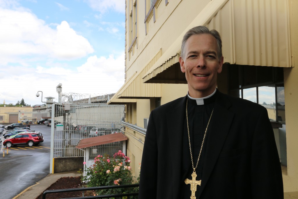 Archbishop Alexander K. Sample of Portland, Ore., stands outside Oregon State Penitentiary in Salem. On May 28, in a heavily-guarded private ceremony, the archbishop confirmed four death-row inmates. He told the men that Christ died on the cross "because he loves you. (CNS photo/Jon DeBellis)