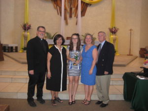 Fr. Greg Schlarb, pastor and Our Lady of Perpetual Help Principal Donna Lauro stands with Rachel Larsen and her parents Polly and Scott. (photo courtesy of Our Lady of Perpetual Help School)