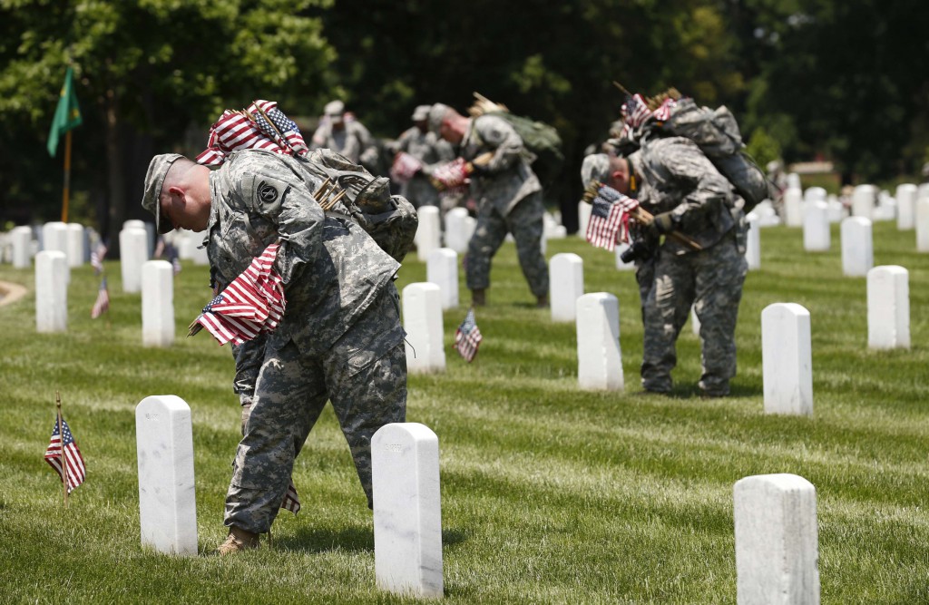 Members of the Third U.S. Infantry Regiment take part in a "Flags-In" ceremony May 22, ahead of Memorial Day, at Arlington National Cemetery near Washington. The soldiers placed American flags in front of more than 220,000 graves. In interviews with Catholic News Service, veterans said Memorial Day doesn't stand out for them, because they always remember their fellow soldiers who died in battle. (CNS photo/Kevin Lamarque, Reuters)