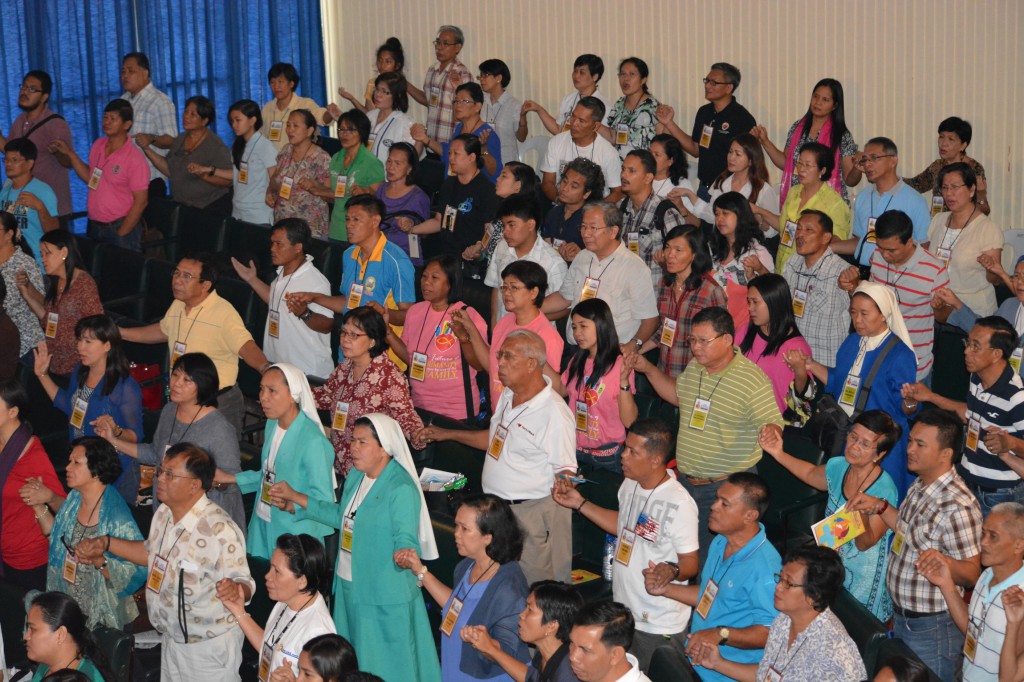 Attendees hold hands while singing the closing song on the final day of the Asian Conference on the Family in Manila, Philippines, May 16. As the conference closed, conference attendees released a message emphasizing that the family is precious to God and must be "highly valued" by everyone. (CNS photo/Simone Orendain)