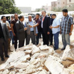 Acting Libyan Prime Minister Abdullah al-Thinni, third from left in front, speaks to the media while visiting the Salah Eddin district after explosions took place at midnight May 21 in Tripoli. Priests in Tripoli and Benghazi say Catholics are "living in fear" as conflict with Islamists nears a showdown in Libya. (CNS photo/Ismail Zitouny, Reuters) 