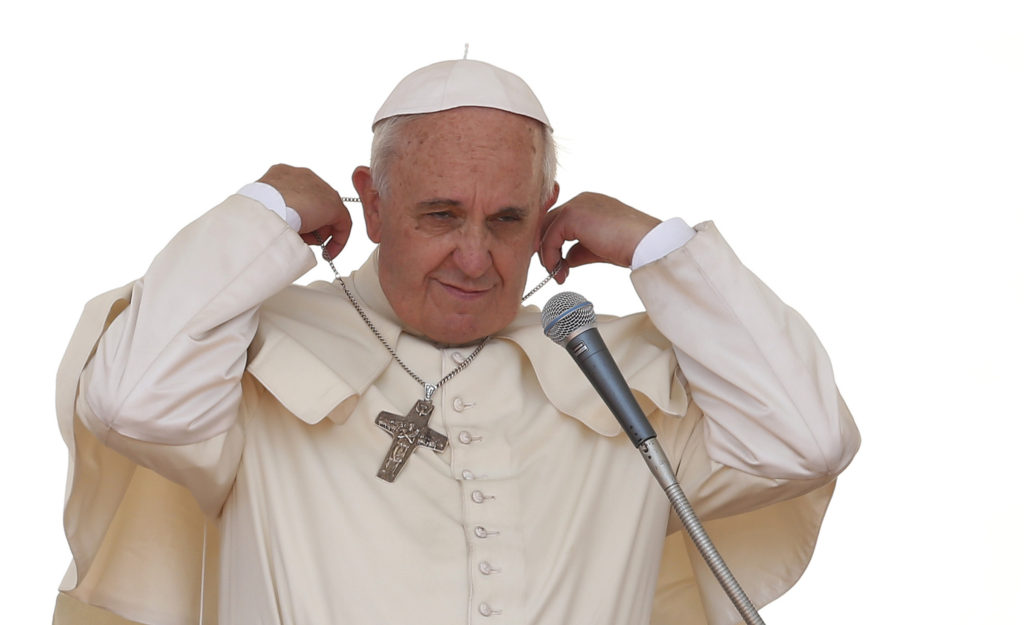 Pope Francis adjusts his pectoral cross as he begins his general audience in St. Peter's Square at the Vatican May 21. (CNS photo/Paul Haring)