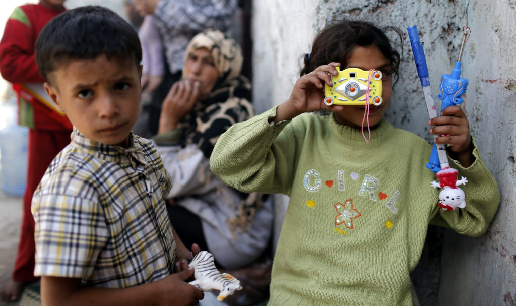 Syrian children from Aleppo play in a shanty near Gaziantep, Turkey, May 25. According to U.N. agencies, more than 40 percent of Syria's pre-war population of 22.4 million has been displaced by the conflict. (CNS photo/Sedat Suna, EPA) 