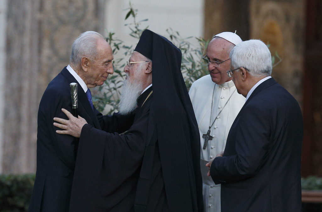 Israeli President Shimon Peres and Ecumenical Patriarch Bartholomew of Constantinople embrace as Pope Francis and Palestinian President Mahmoud Abbas look on during invocation for peace in the Vatican Gardens June 8. (CNS photo/Paul Haring)  