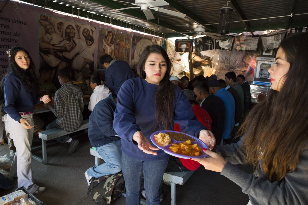 Kino Teens volunteers  Angelica Ortiz, Marian Enriquez and Nicole Davison serve dinner to recently deported migrants in the kitchen and dining hall of Centro de Atencion al Migrante Deportado (Aid Center for Deported Migrants) in Nogales, in the Mexican state of Sonora. The volunteer group was started at Lourdes Catholic School in Nogales, Ariz., and supports the Catholic-run Kino Border Initiative, which works for more humane and viable solutions to immigration issues. (CNS photo/Nancy Wiechec)