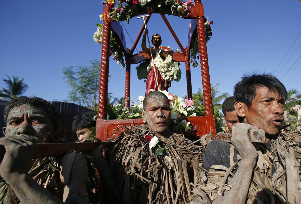 Filipinos carry a statue of St. John the Baptist June 24 as they take part in a religious ritual known locally as "Taong Putik" (Mud People) in the village of Bibiclat, Philippines, while celebrating the feast of their patron saint. At the Vatican, Pope Francis also celebrated the feast of the birth of St. John the Baptist and called him "the greatest among the prophets." (CNS photo/Erik De Castro, Reuters)